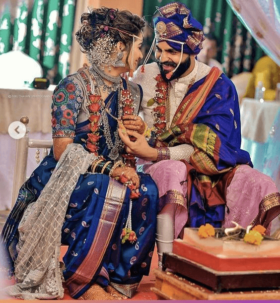 Wedding couple are sit on chair and smiling to see on each other eyes.